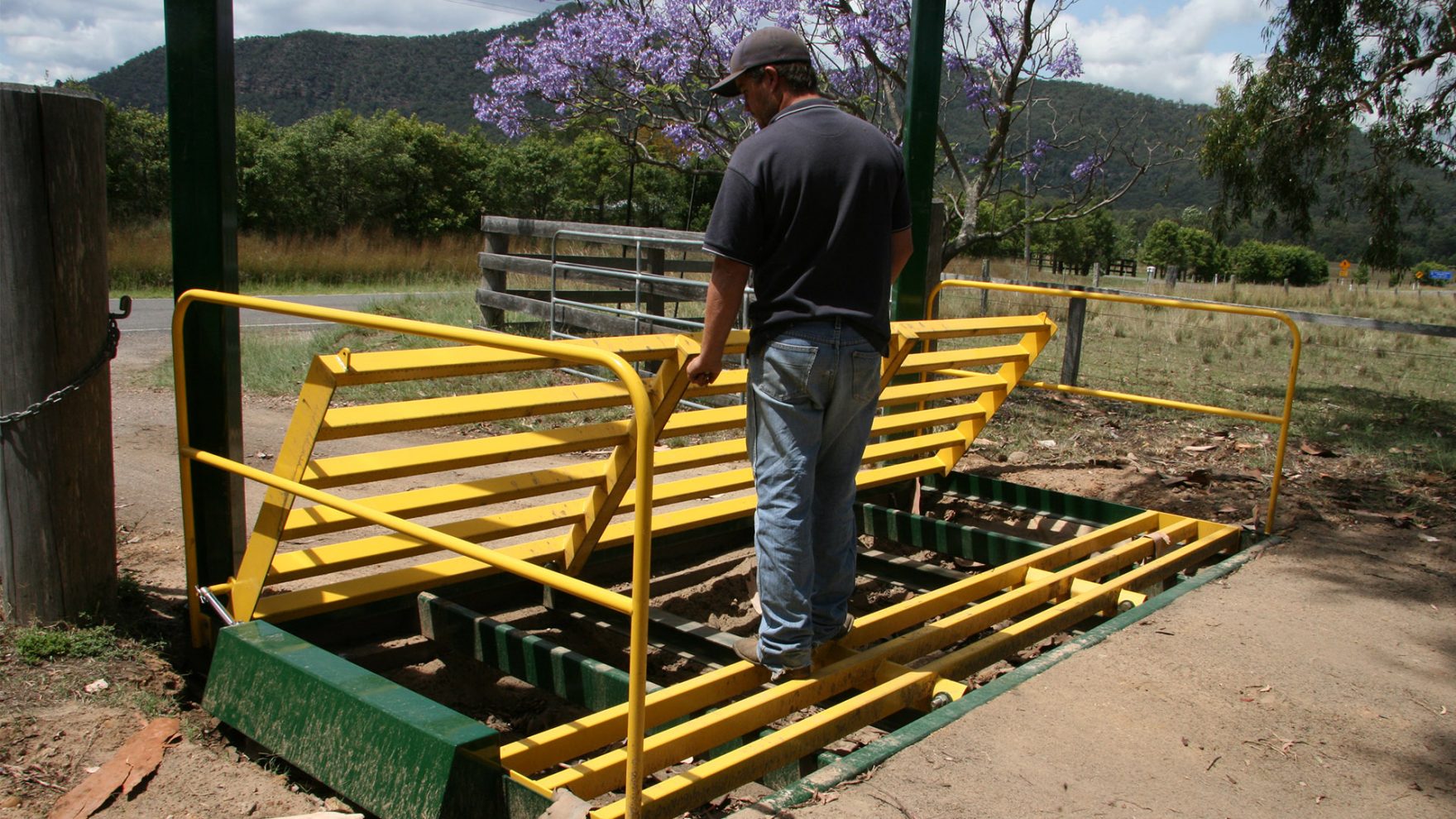 Milbotec worker installing a cattle grate gate.