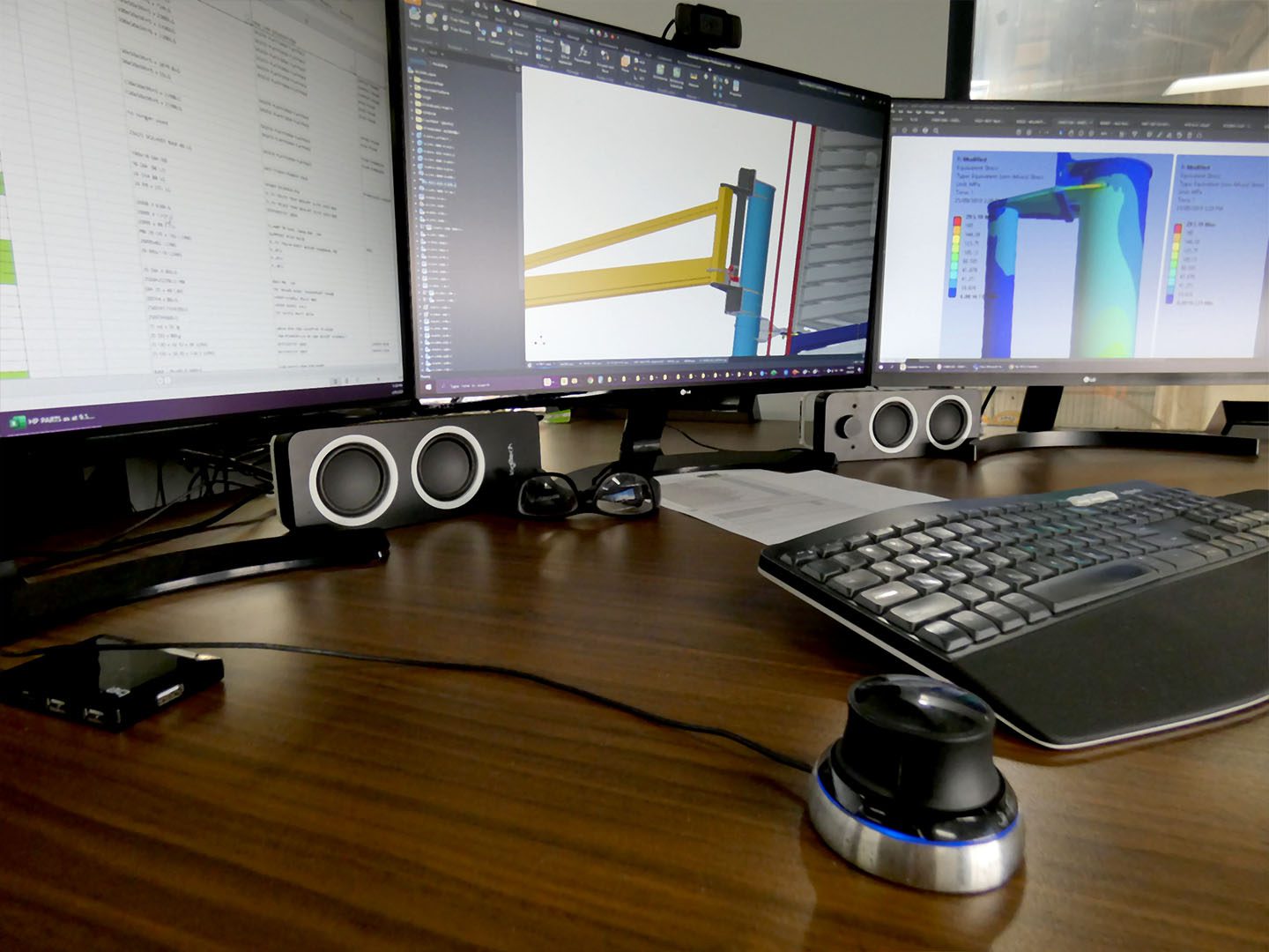 a triple monitor work station being used for 3d modeling