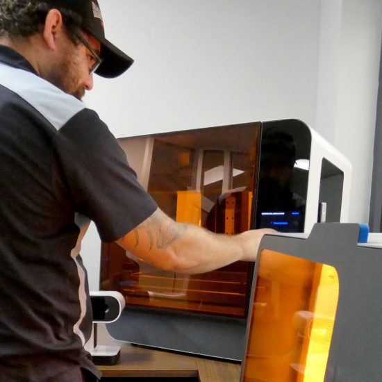 mecensol employee using 3d printers.